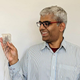 Lead author Gopala Anumanchipalli holding an intracranial electrode of the type used to record brain activity in the new study.